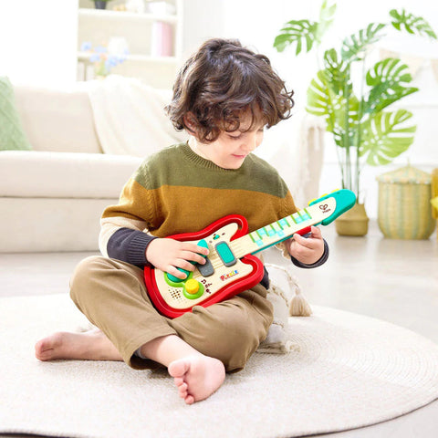 Hape Pixelz Rainbow Rock Pixel Guitar toy in red packaging for ages 3-6