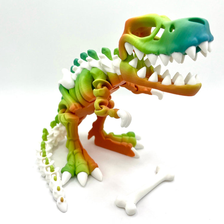 3D printed T-Rex skeleton figurine in vibrant rainbow color gradient with white bone details