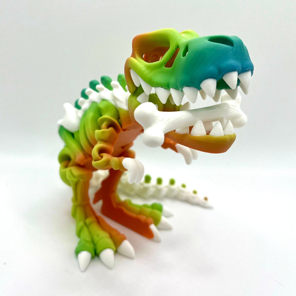 3D printed T-Rex skeleton figurine in rainbow gradient colors with white bone details