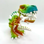 3D printed T-Rex skeleton figurine in rainbow gradient colors with white bone details