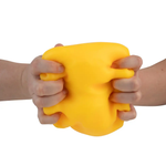 Two hands squeezing a large yellow cheese-shaped stress relief squeeze toy