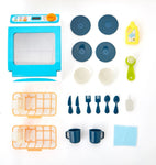 Magic Rinse toy dishwasher playset with blue appliance, plates, cutlery, cups, racks, and accessories laid out.