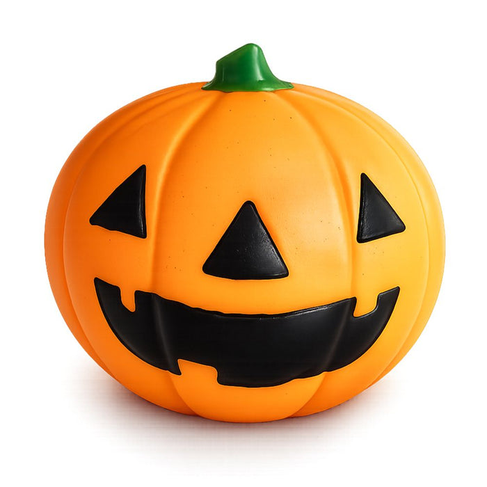 Orange jack-o-lantern squishy toy with black carved face and green stem