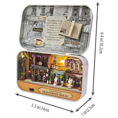 DIY miniature Old Coffee House kit displayed open in decorative tin box with illuminated diorama