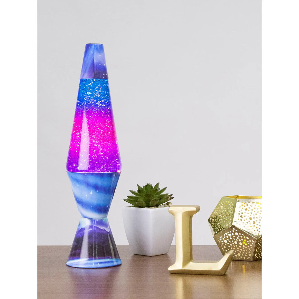14.5-inch Northern Lights glitter lava lamp with blue base and vibrant pink-purple liquid on wooden shelf