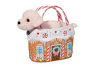 White plush puppy toy sitting inside a gingerbread house themed carrier bag with candy cane handles