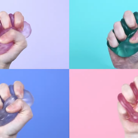 Pink stress ball packaging with 'SPEKS' branding on a light green background